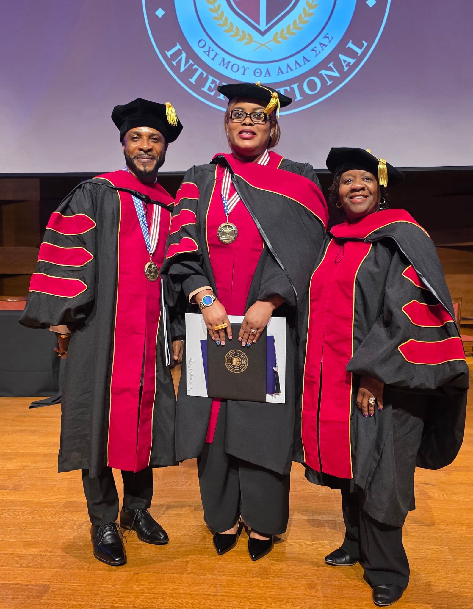 Three ministers in doctoral robes at a graduation ceremony